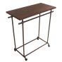 A high-angle view looking down at an empty dark grey pipeline double-bar clothing rack showing dark wood top shelf.