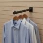 Industrial Pipeline Slatwall Faceout displaying men’s dress shirts on wooden hangers for retail merchandising