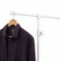 White industrial pipe clothing rack detail with hanging men's dress shirt