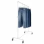 White industrial garment rack holding multiple pairs of blue jeans this rack has a heavy-duty weight capacity.