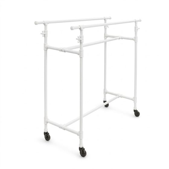 White industrial pipe double clothes rack with adjustable rails for boutique apparel display.